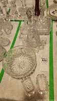 Overview of set on table showing various crystal glassware items including bowl, decanter, glasses, and smaller containers.