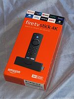 Box of the Amazon Fire TV Stick 4K HDR showing front with logos of supported apps and product image.