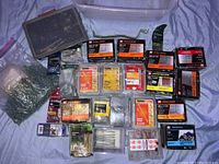 Boxes and bags of assorted screws, nails, and anchors including brands GRK and others, all appearing unopened and unused.