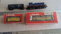 All four toy trains with two in original boxes.