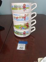 Stack of four vintage Campbell's soup mugs/bowls with illustrated children playing outdoors