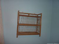 Full view of the three-tier bamboo and wicker shelf showing its structure and design