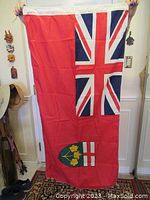 Ontario flag hanging flat, showing British Union Jack and Ontario shield with red background.