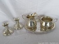 Full lot overview including cream pitcher, sugar bowl, tray, and candlestick holders