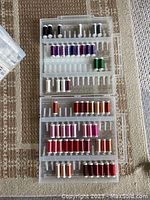 Open Slimline Storage Box showing 59 spools of Sulky thread organized by color across multiple tiers.