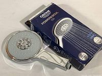 Photo of Grohe Powersoul 130 shower head with its original blue box showing.