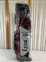 Front view of the Lynx golf bag in original plastic wrapping showing logo and color scheme.