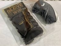 Set of black fabric headcovers including a cover labeled number 3, in a plastic bag