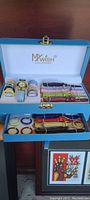 Opened MyWish Collection box showing multiple interchangeable watch faces and colorful watch straps, organized inside a two-tier blue case.