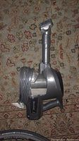 Side view of Rocket handheld vacuum cleaner showing handle and power cord wrapped around it.