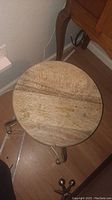 Top view of the round wooden stool seat showing wood grain and wear.