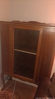 Wooden hutch with glass door and visible wood grain from front and side angles