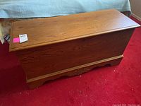 Overview of Lane cedar chest closed on red carpet