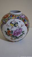 Front view showing bird and floral medallion design on vase