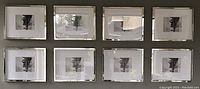 Eight matching rectangular wall frames arranged in two rows of four. Each frame has beveled mirrored edges and white matting with a center window for 8x10 photos. Frames have reflective surfaces showing light and shadows. Image taken from the front.
