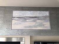 Close-up of the abstract landscape painting displayed on a silver metallic textured background panel.