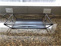Front angle view showing the full rectangular tray with integrated handles and geometric crossbar frame.