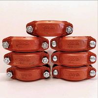 Photo showing seven red Victaulic 3-inch 107V couplings stacked in two groups.