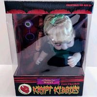 Front view of the Krypt Kiddies Series 2 Mauly doll in original box, showing doll with blonde hair, green outfit, and box branding.