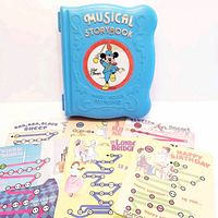 Front cover of blue plastic storybook with Mickey Mouse graphic and 'Musical Storybook' text, shows included music sheets with nursery rhymes and children's songs