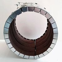 Top view of circular metal firestop collar with segmented inner lining and latch mechanism for closure.
