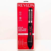 Front of box showing Revlon 2-in-1 hairdryer brush curling iron in packaging with usage details and product image.