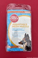 Photo of Grreat Choice branded adjustable mesh muzzle in original packaging showing product details and features.