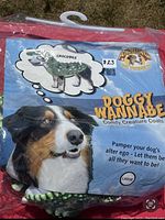 Crocodile dog costume in original packaging showing label with costume theme, size large, and brand name.