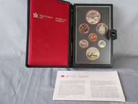 Complete coin set in black presentation book with certificate and Royal Canadian Mint logo on red inner cover.