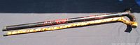 Full view of two wooden canes showing length and design features.
