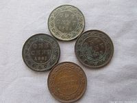Four Canadian large cent coins dated 1881, 1882, 1905, and 1917.