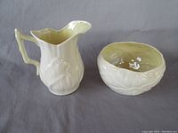 Cream pitcher and sugar bowl side by side showing overall design and condition