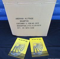 Two 8-piece Allen key sets displayed on yellow and black packaging, each with a ring holding the metal hex keys.