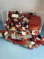Mixed LEGO blocks and baseplates in plastic storage shoe box