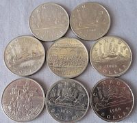 Eight Canadian one dollar coins arranged in two rows on a white cloth background. Coins dated prominently 1981, 1982 (Confederation), 1983, 1985, and 1986. Various designs seen including the voyageur canoe featuring a canoe with two voyageurs and bundles of goods, a commemorative 1982 Confederation coin showing parliamentary scene, and a coin depicting Jacques Cartier.