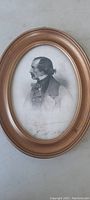 Full view of the 8 inch oval framed engraving showing the 19th century styled male portrait under glass.