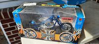 Blue cherry CFL die cast chopper motorcycle in original box with visible dust and price tag.