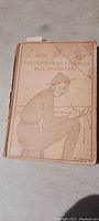 Photo of the full book cover showing title, author, and comic style illustration of WWI soldier writing a letter.
