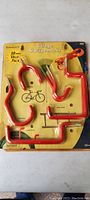 Original unopened packaging showing 10 piece heavy hook set with red coated hooks designed for garage storage.