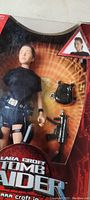 Front view of the Lara Croft Tomb Raider action figure in original packaging showing the figure and accessories such as backpack and weapons.