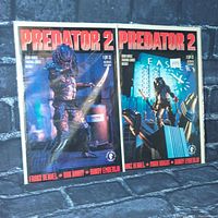 Two Predator 2 comic books from Dark Horse Comics, issues 1 and 2, upright on a stone-like background.