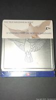 Photo of Canada Post Millennium collection coin with bird design and packaging labeled with price tag.