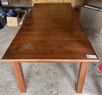 Top-down view of the rectangular wooden dining table showing the surface finish and table legs.
