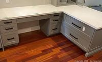 Front perspective showing desk section with drawers under countertop