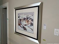 Framed print of a snowy village scene with a church and houses in the Laurentians.