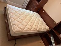 Full view of the open Murphy bed showing mattress and wood frame