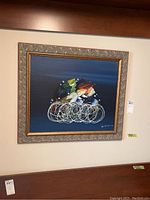 Full front view of framed painting hung on wall