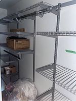 Installed closet shelving system showing overall layout with multiple wire shelves and hanging rods