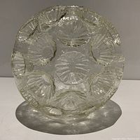 View from top showing deep impressed floral pattern on clear glass surface of vintage MCM glass shade.