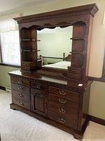 Front view of Thomas P. Beals dresser with hutch mirror, showing multiple drawers, central cabinet, and large mirror framed by decorative columns and shelving.